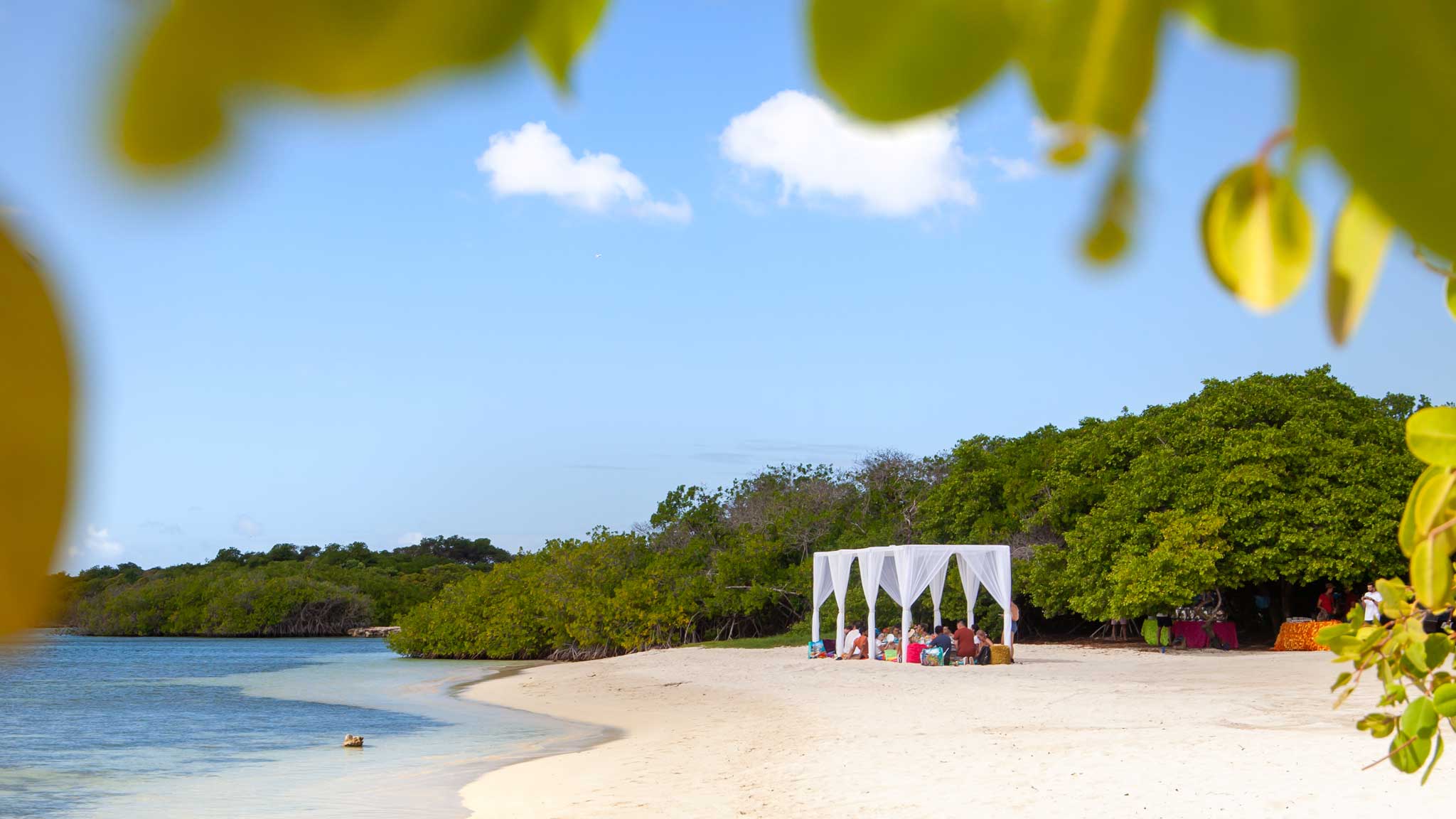 A white sand beach on Aruba with a private dining Cabanna