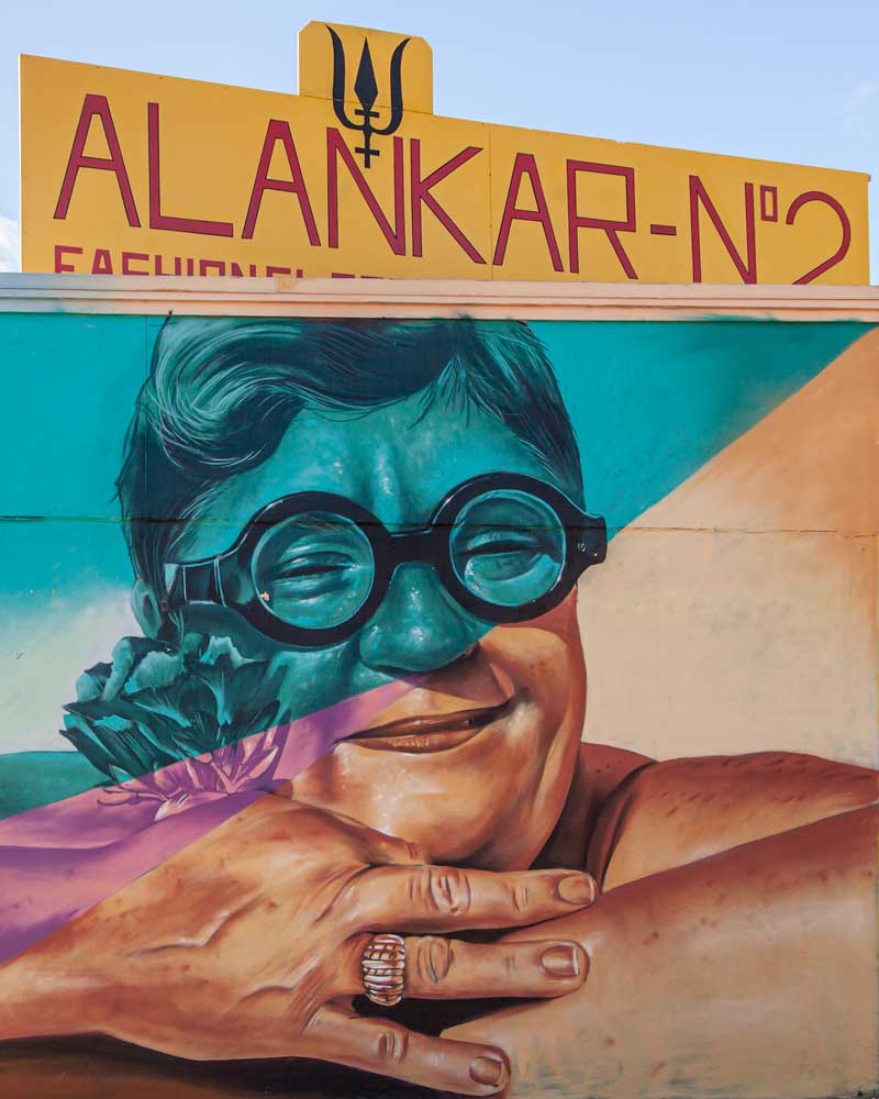 Street art of a smiling aunty with sunglasses in San Nicolas