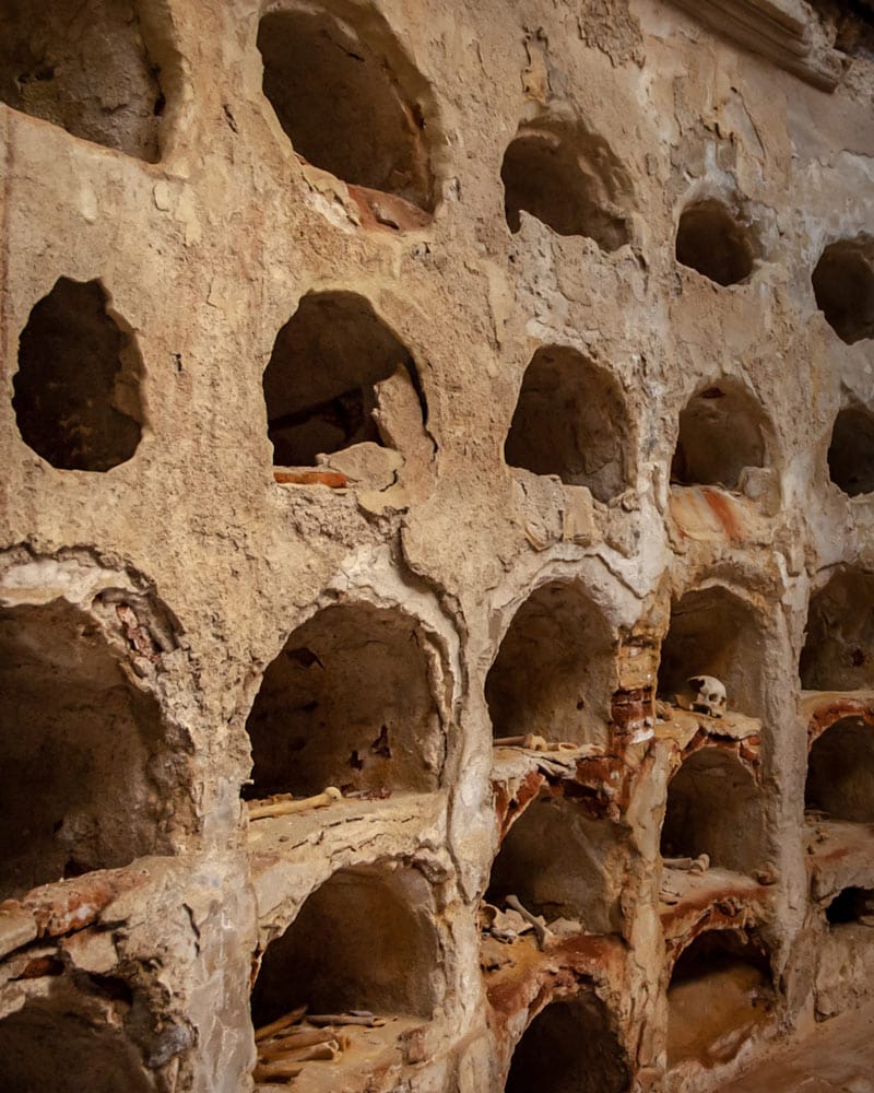 Inside the remains of the wall where a skull sits