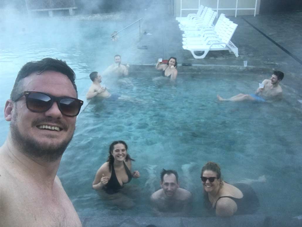 Relaxing in a hot spring with drinks