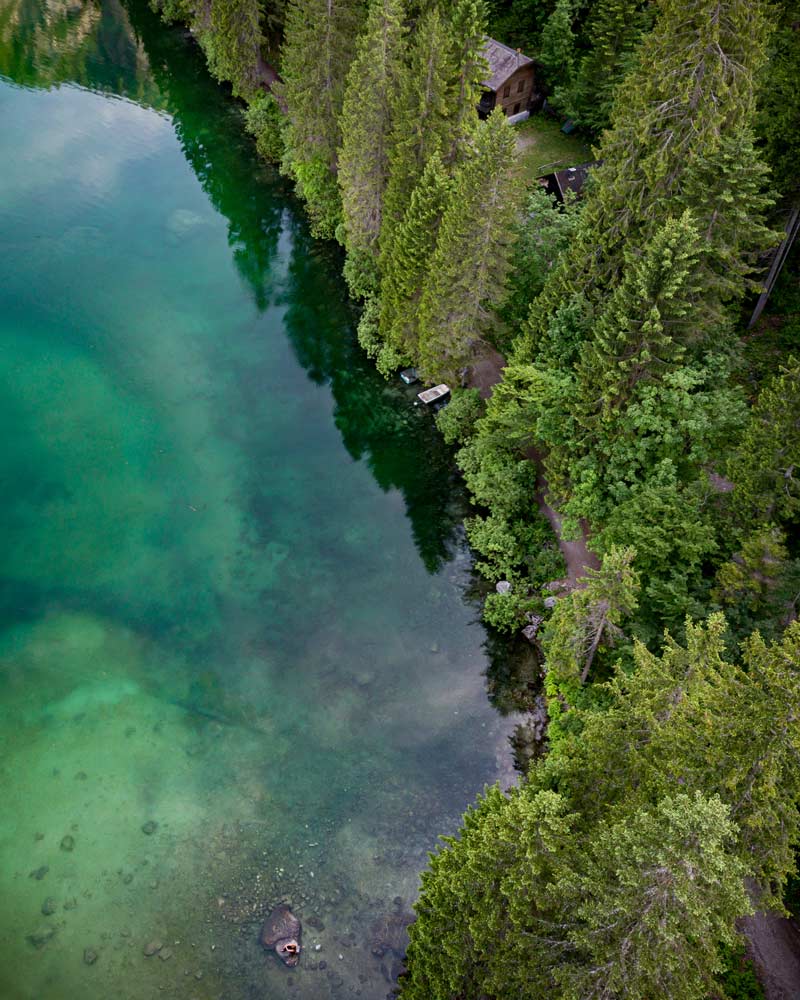 Lago di Tovel as seen from above with an alpine forest on its edge