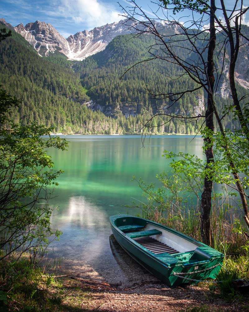 A boat sits by the edge of Lake Tovel in Trentino