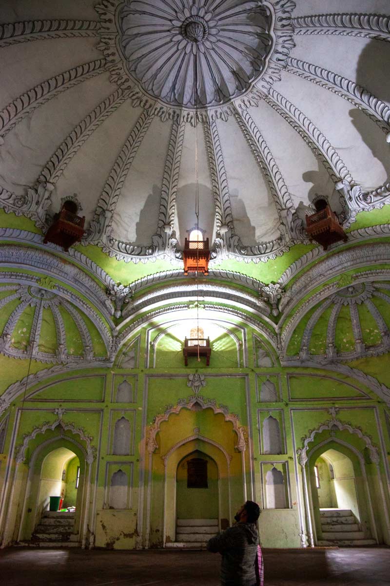 A green wall meets a white domed roof inside the Bara Imambara Mosque Lucknow India