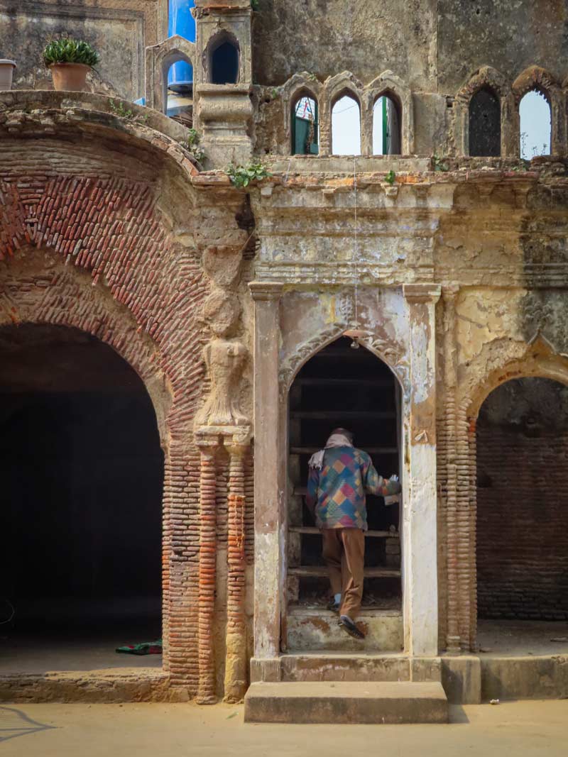 A man steps into the staircase which leads to the first floor mosque