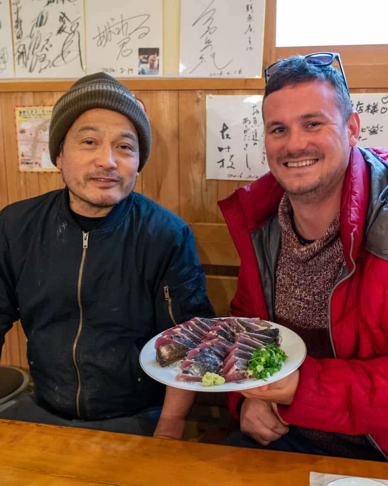 Dan and the chef sit with a plate of Katsuo no Tataki