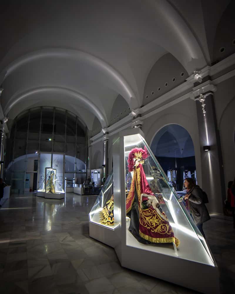 An expensive outfit of Lorca embroidery sits in a glass frame in the museum