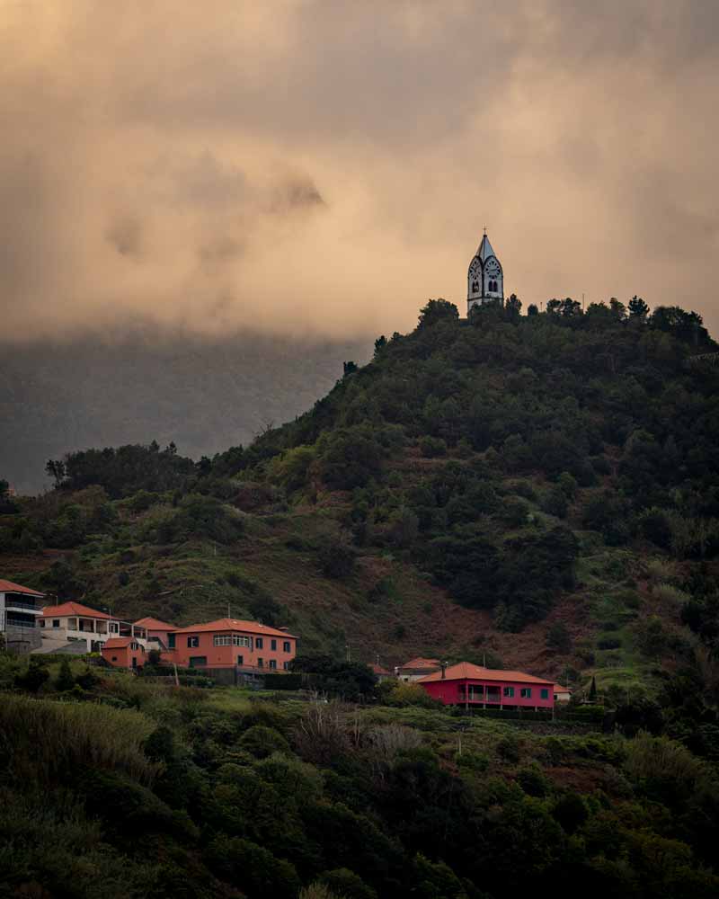 A church spire that sits a top of a fill, not connected to any other building